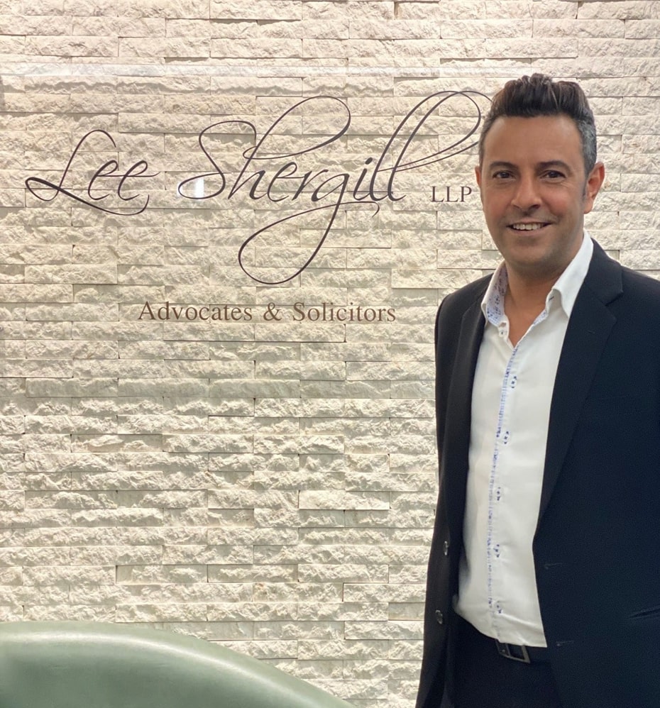 Raj Singh Shergill beside the complete Lee Shergill LLP office signage